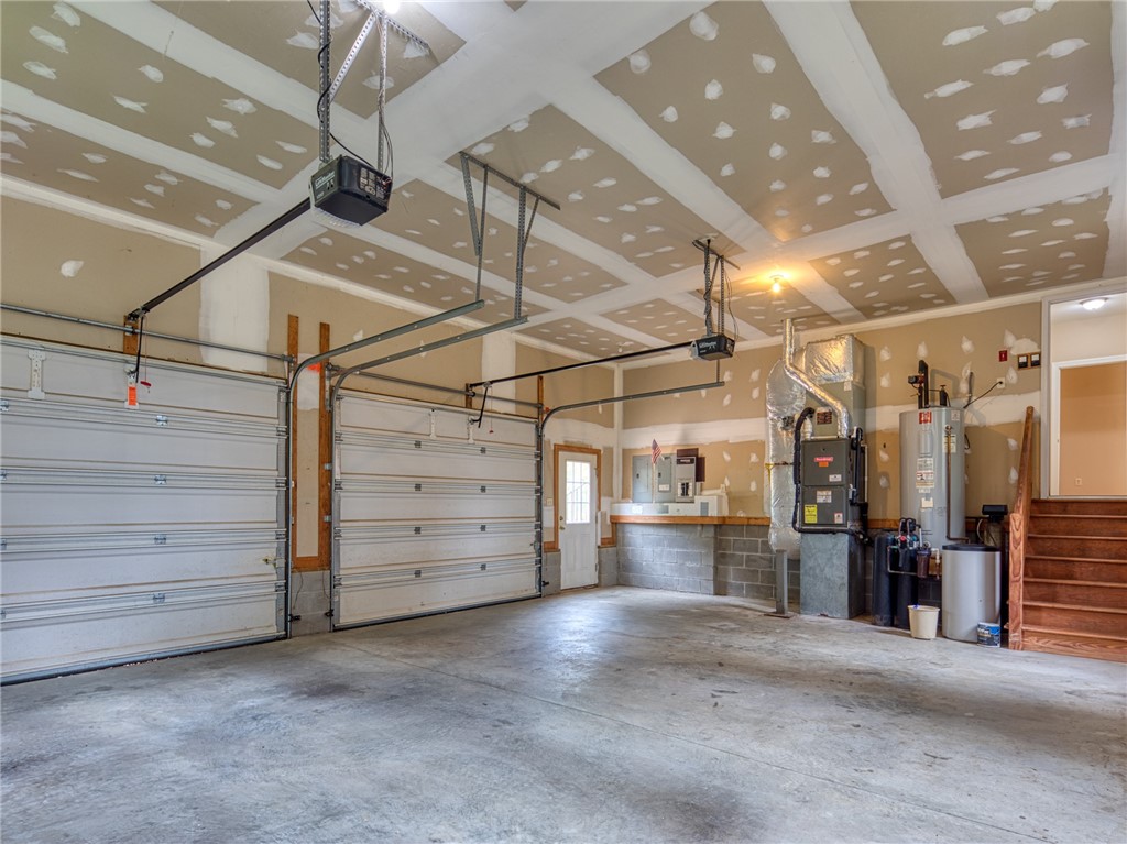 7914 O Neil Road Gloucester, VA 23061 - Photo 44 of 47 Garage with a garage door opener and electric water heater