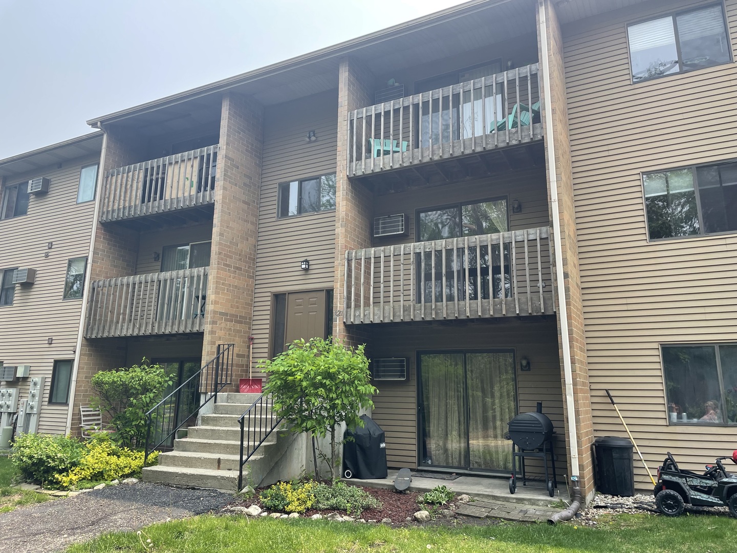 627 South Virginia Road, Unit 211 Crystal Lake, IL 60014 - Photo 1 of 1 a front view of a house with garden