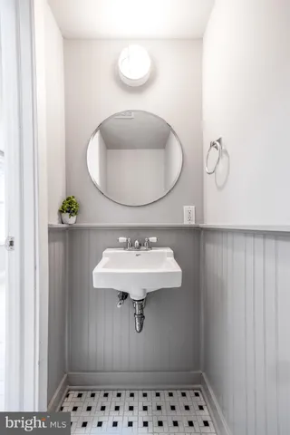 a bathroom with a sink a vanity and a mirror