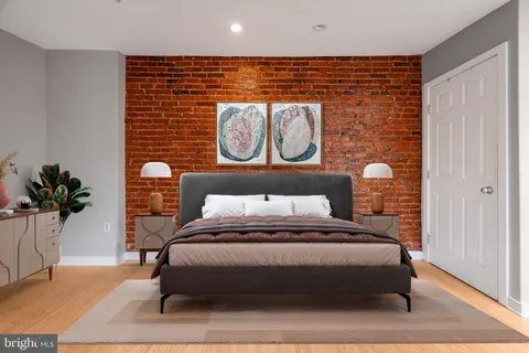 a bedroom with a bed and a potted plant