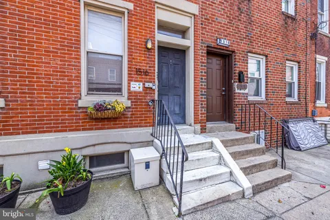 an outdoor view of a house with a potted plant