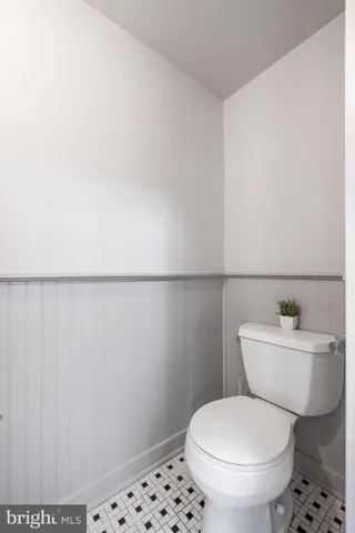 a white toilet sitting next to a bathroom sink