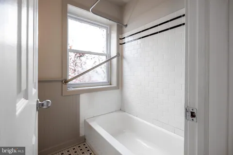 a white bath tub with a shower