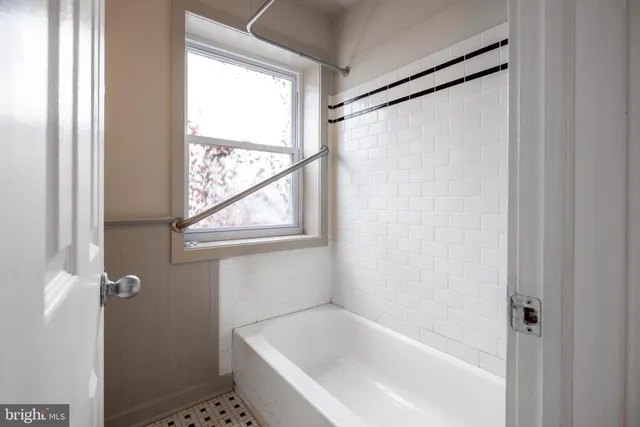 a white bath tub with a shower