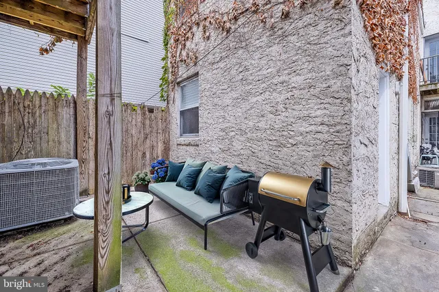 a view of a patio with couches and a fireplace