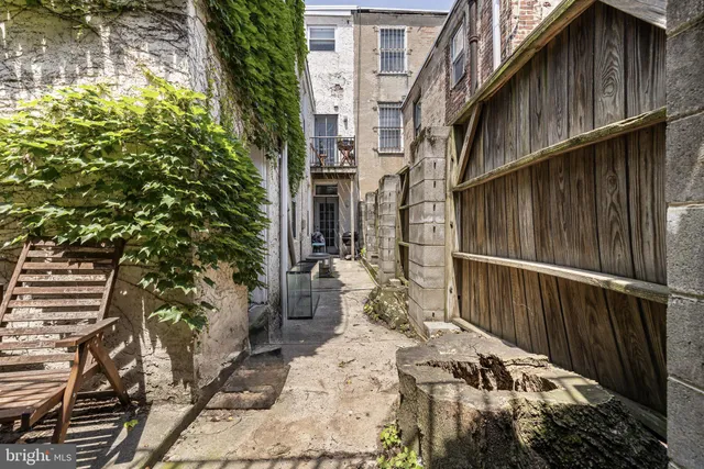 a view of a house with a wooden bench