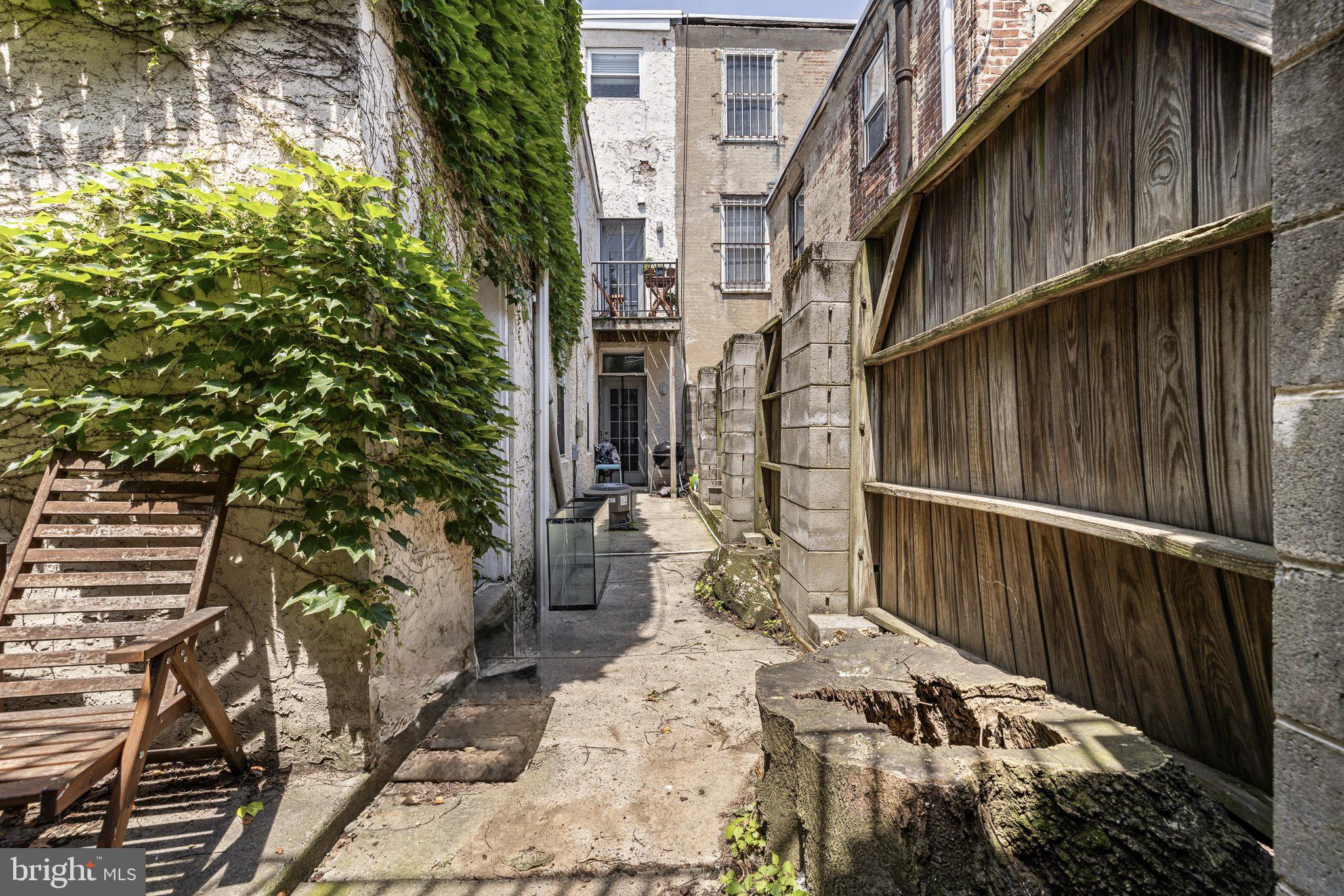 1516 Catharine Street, Unit 2 Philadelphia, PA 19146 - Photo 27 of 31 a view of a house with a wooden bench