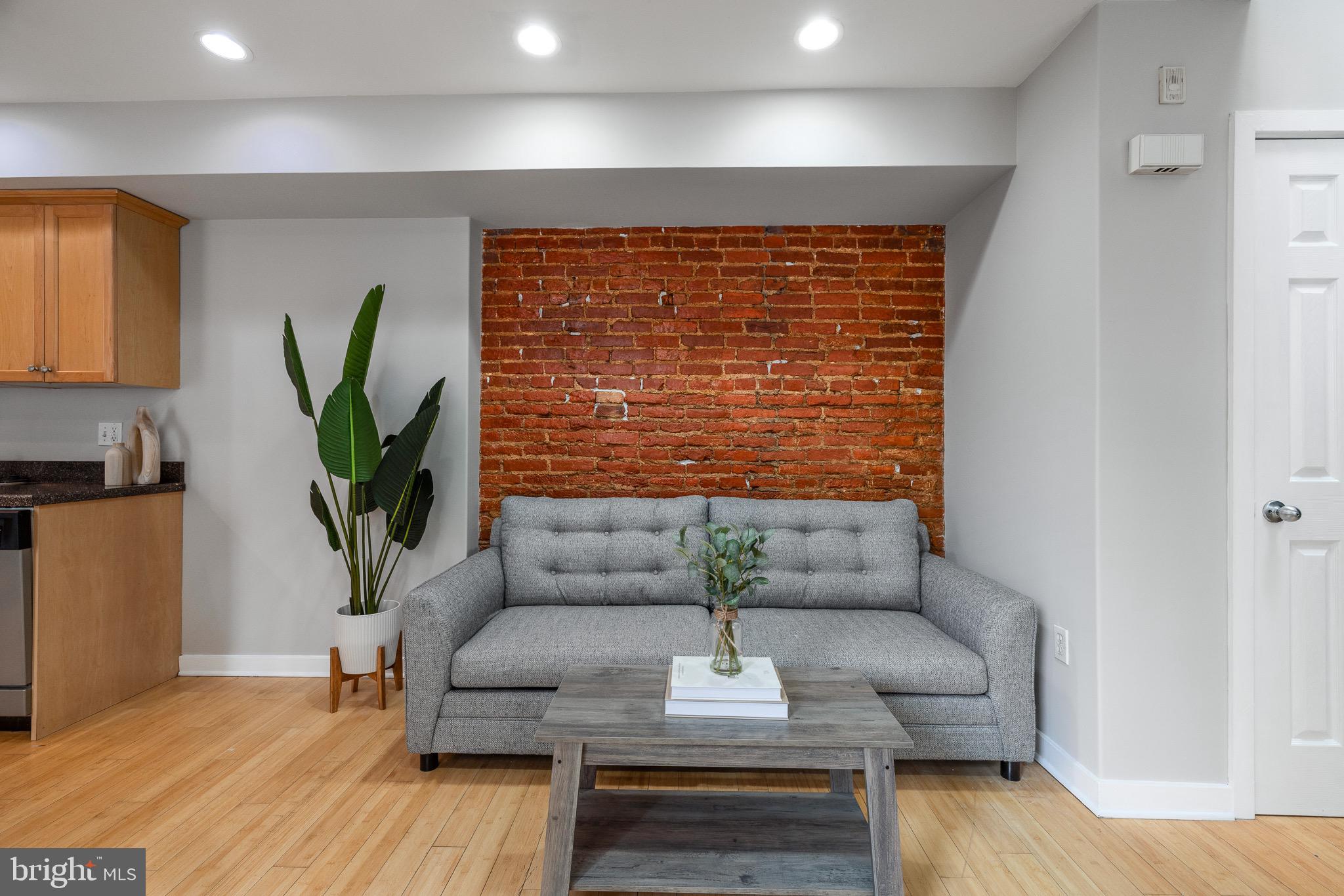 1516 Catharine Street, Unit 2 Philadelphia, PA 19146 - Photo 6 of 31 a living room with furniture a potted plant and a wooden floor