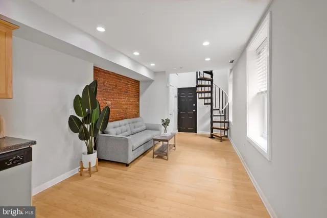 a living room with furniture and a potted plant