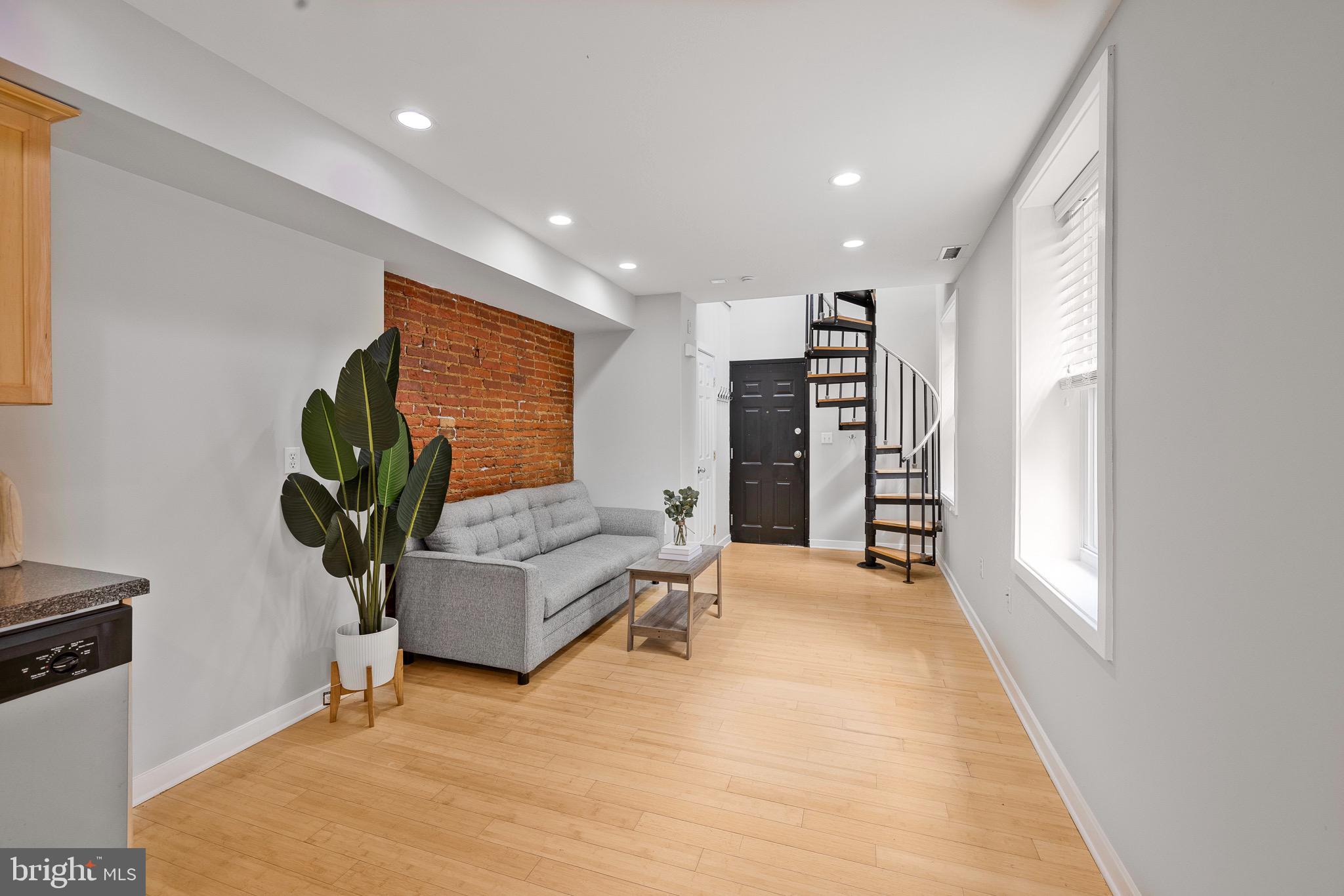 1516 Catharine Street, Unit 2 Philadelphia, PA 19146 - Photo 8 of 31 a living room with furniture and a potted plant