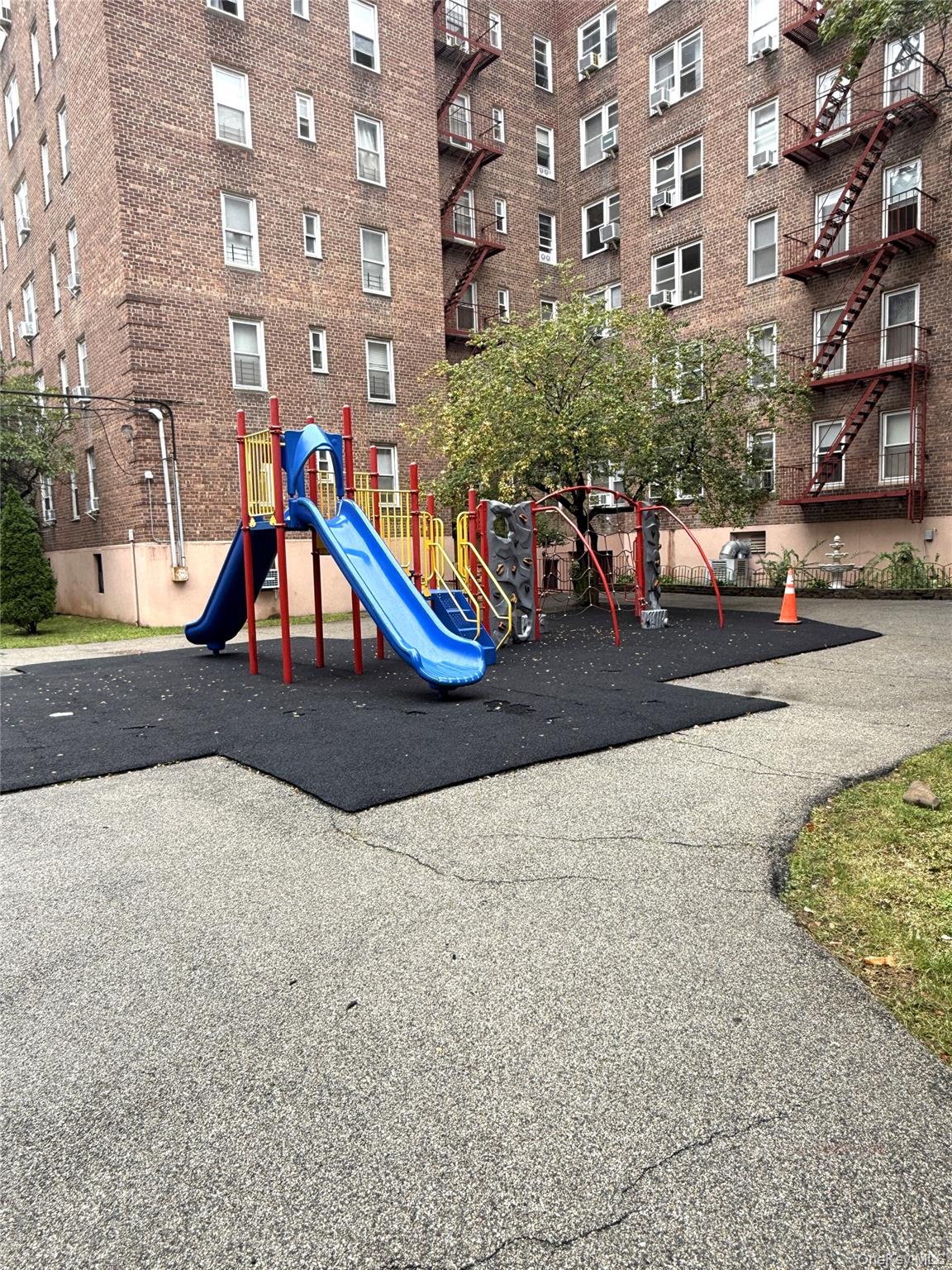 33-25 90th Street, Unit 5D Queens, NY 11372 - Photo 14 of 18 a wooden bench sitting in front of building