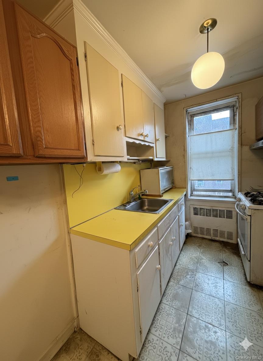 33-25 90th Street, Unit 5D Queens, NY 11372 - Photo 7 of 18 a kitchen with a sink and cabinets