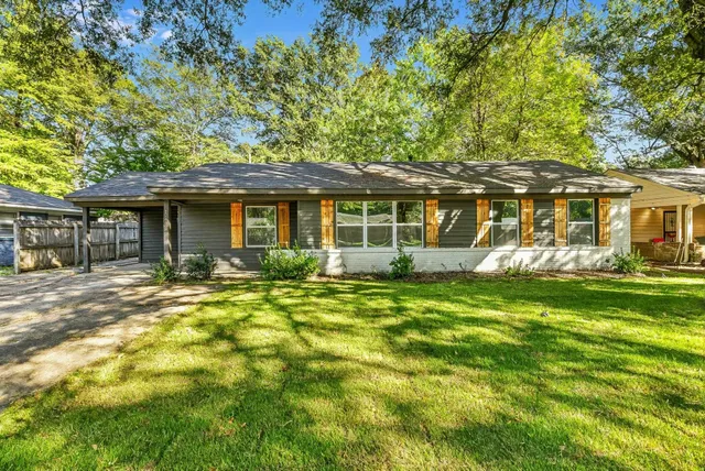 a front view of a house with a garden