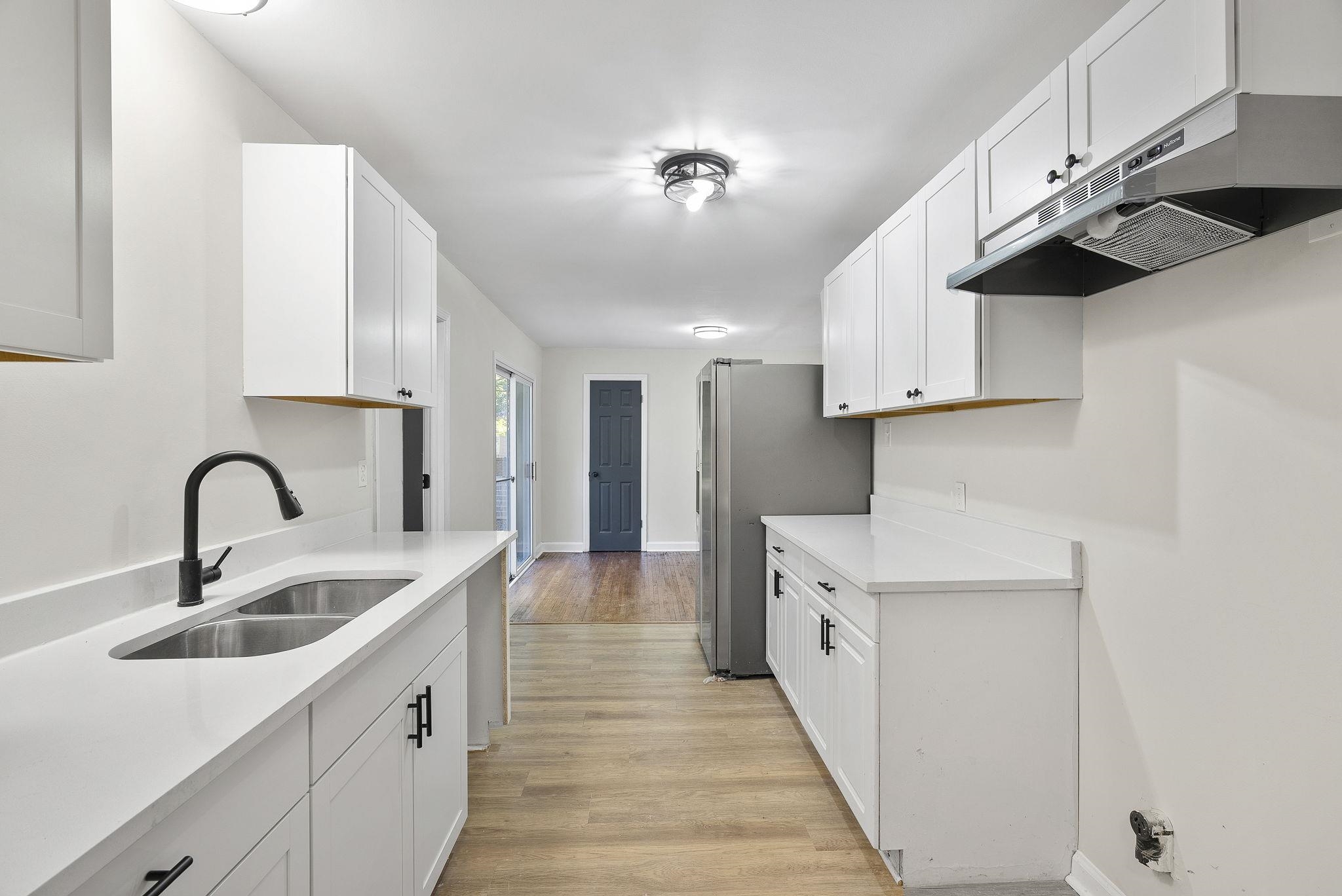 1168 South Perkins Road Memphis, TN 38117 - Photo 12 of 34 a kitchen with kitchen island a sink appliances and cabinets