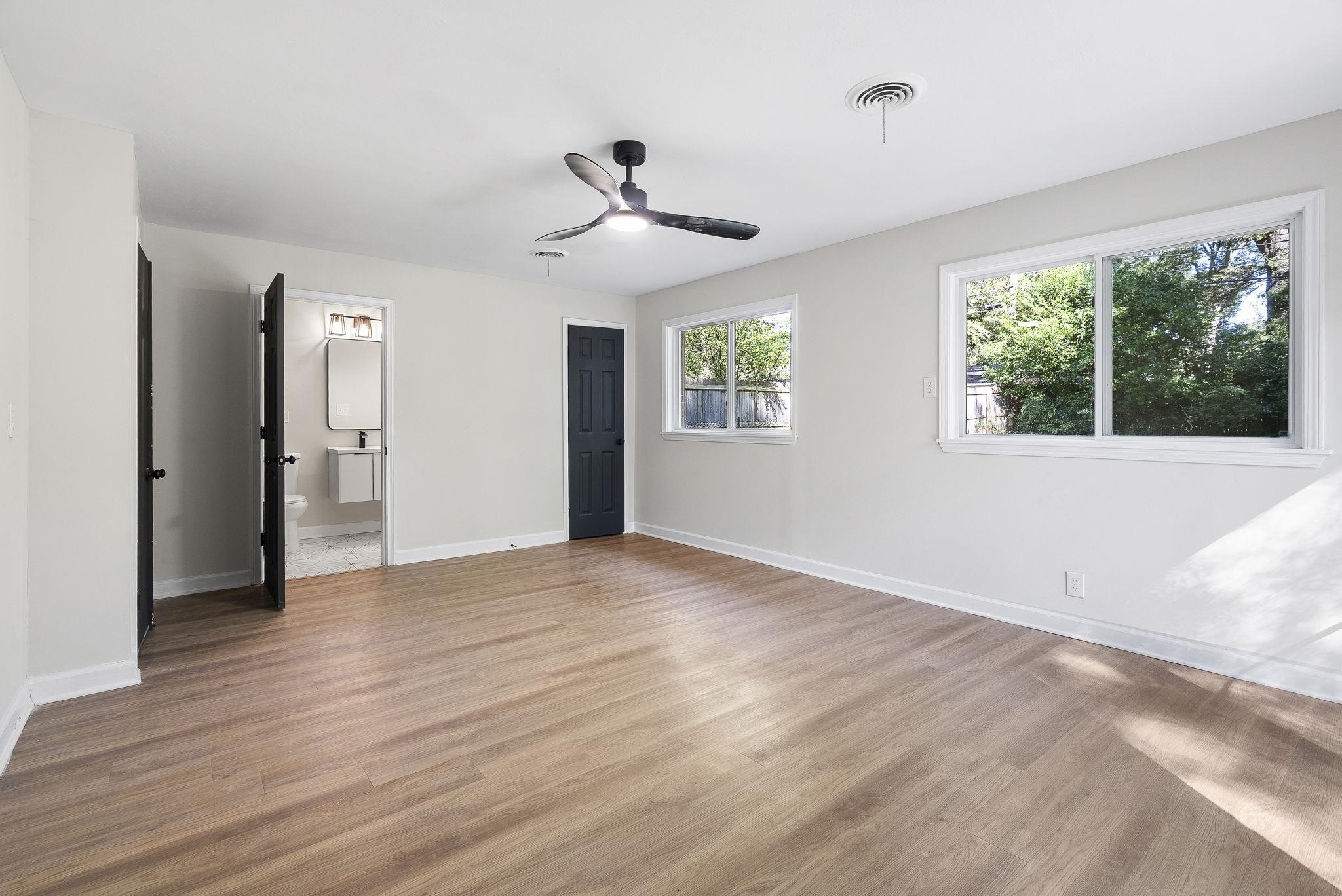 1168 South Perkins Road Memphis, TN 38117 - Photo 16 of 34 a view of an empty room with a window and wooden floor