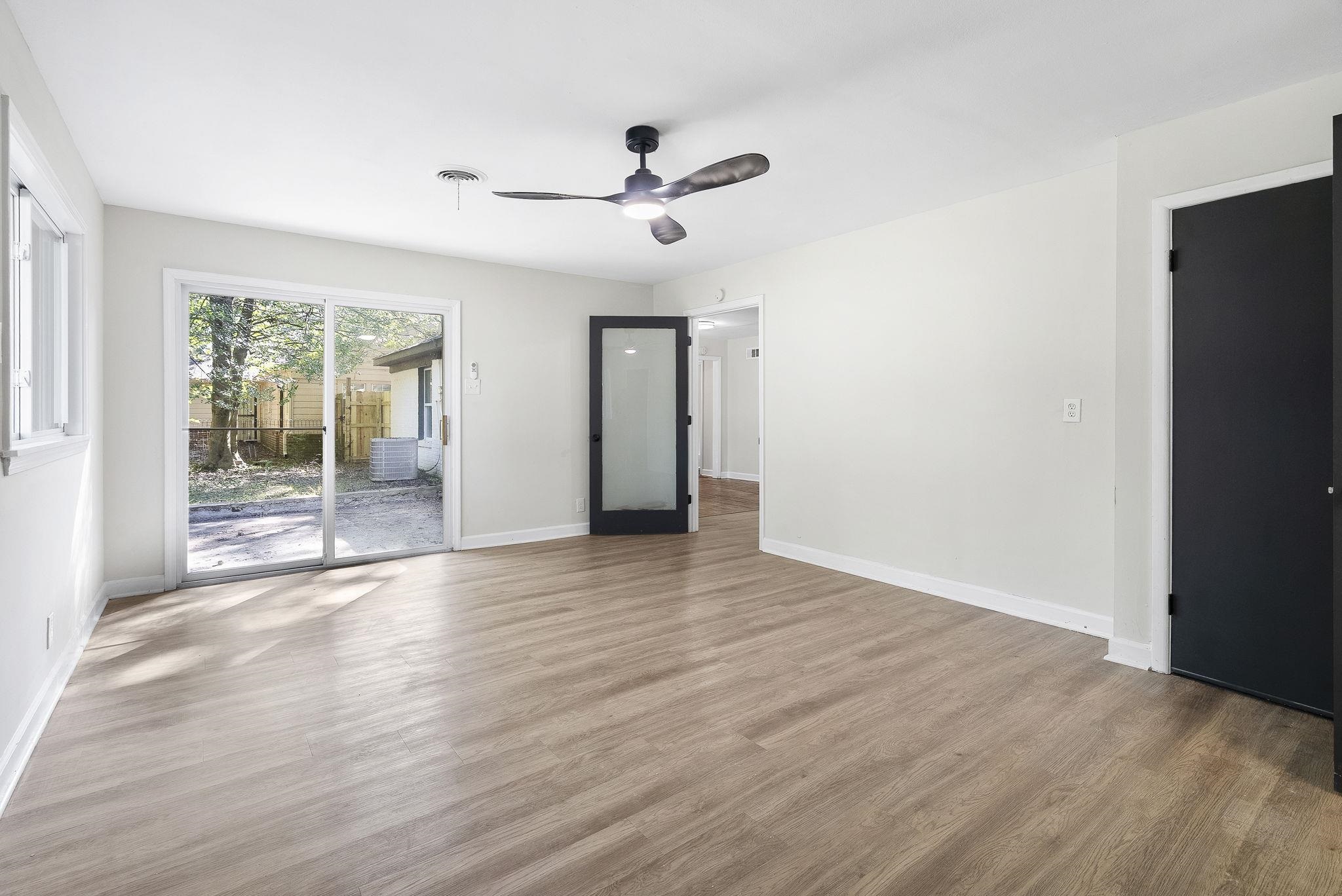 1168 South Perkins Road Memphis, TN 38117 - Photo 17 of 34 a view of an empty room with wooden floor and a window