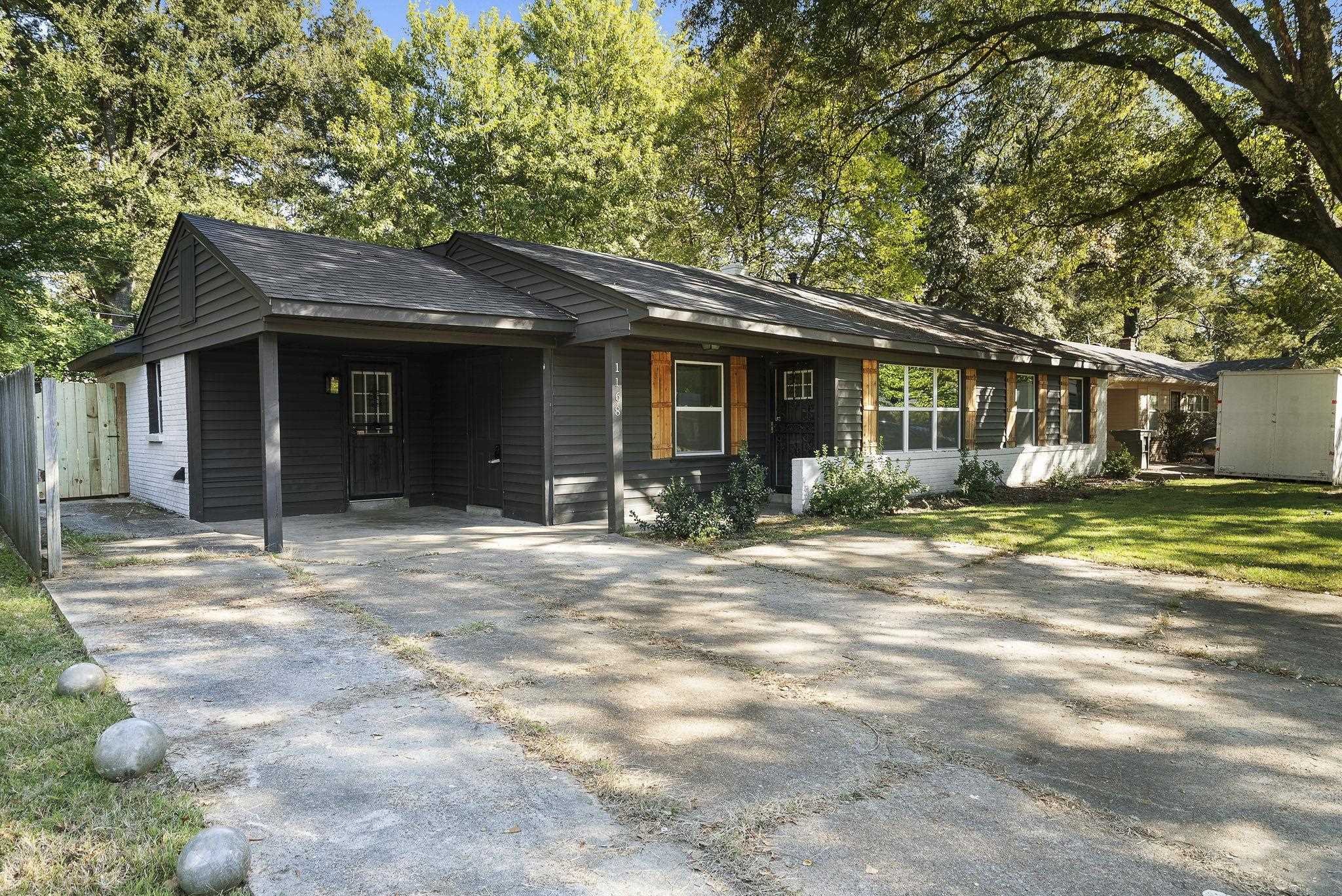 1168 South Perkins Road Memphis, TN 38117 - Photo 2 of 34 a front view of a house with a garden