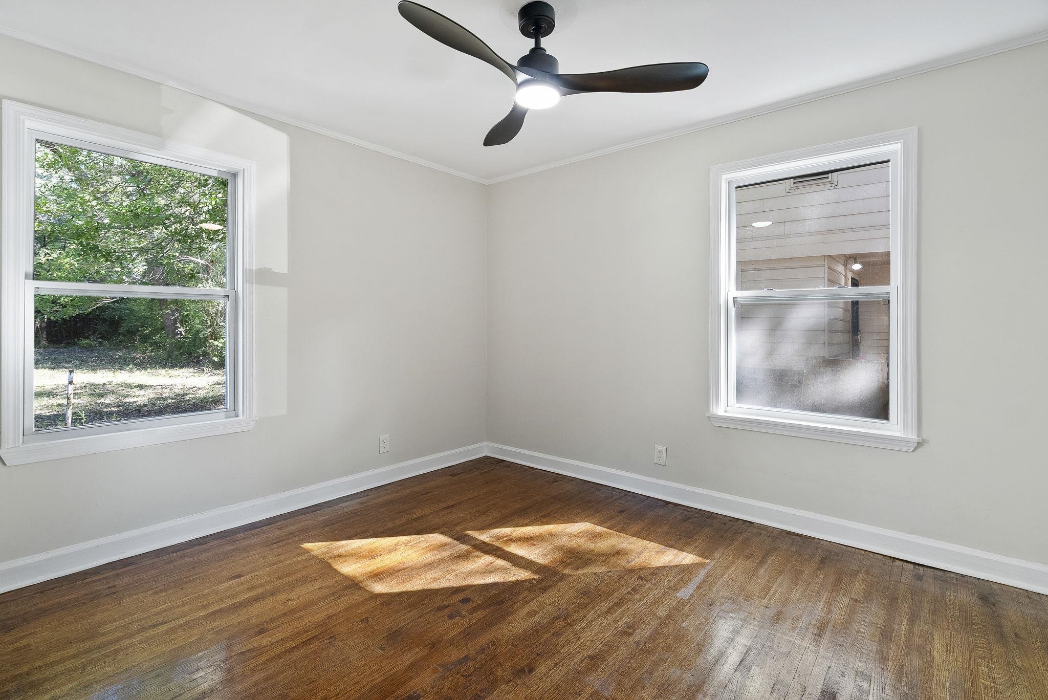 1168 South Perkins Road Memphis, TN 38117 - Photo 22 of 34 a view of an empty room with wooden floor and a window