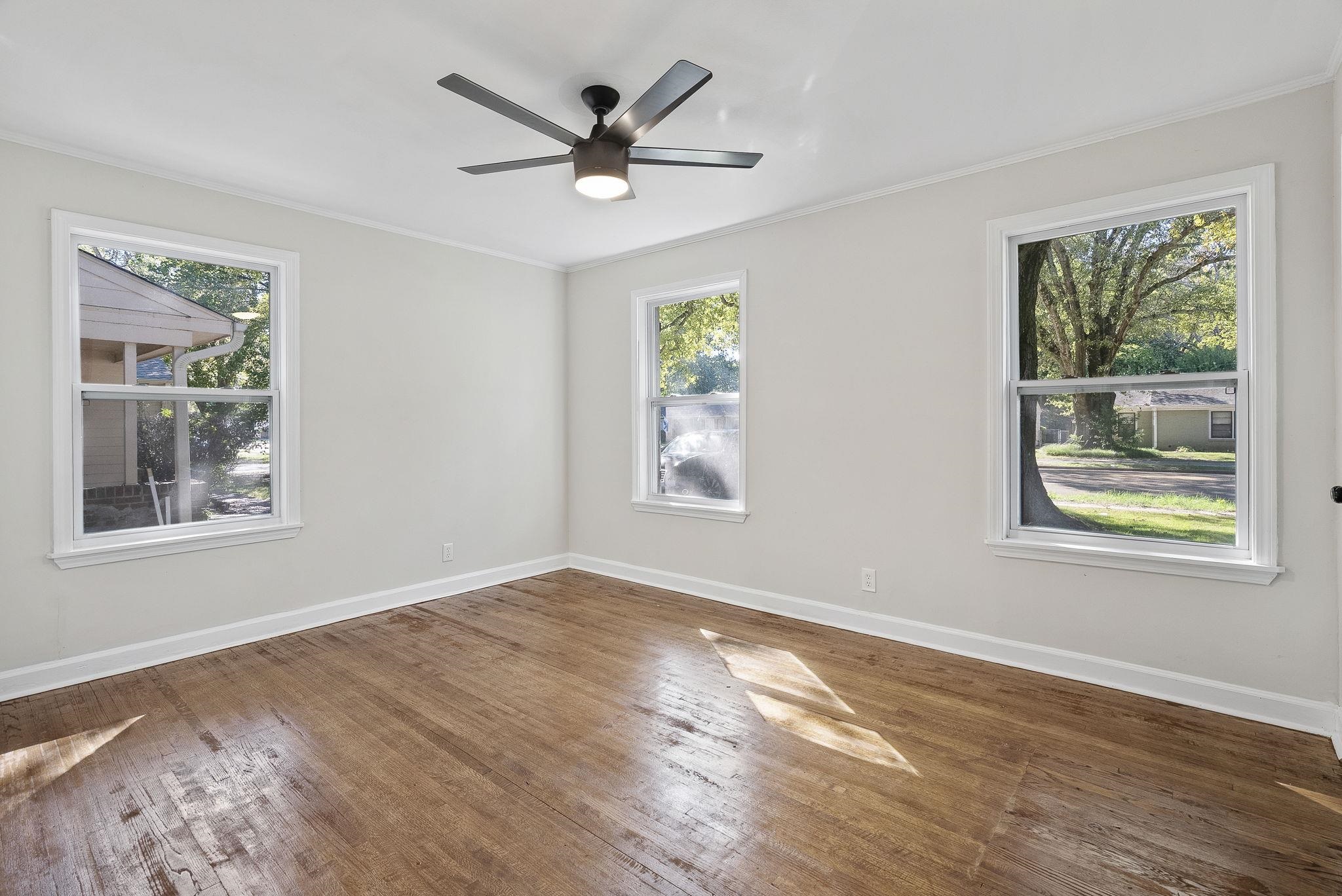 1168 South Perkins Road Memphis, TN 38117 - Photo 25 of 34 a view of a big room with wooden floor and a window