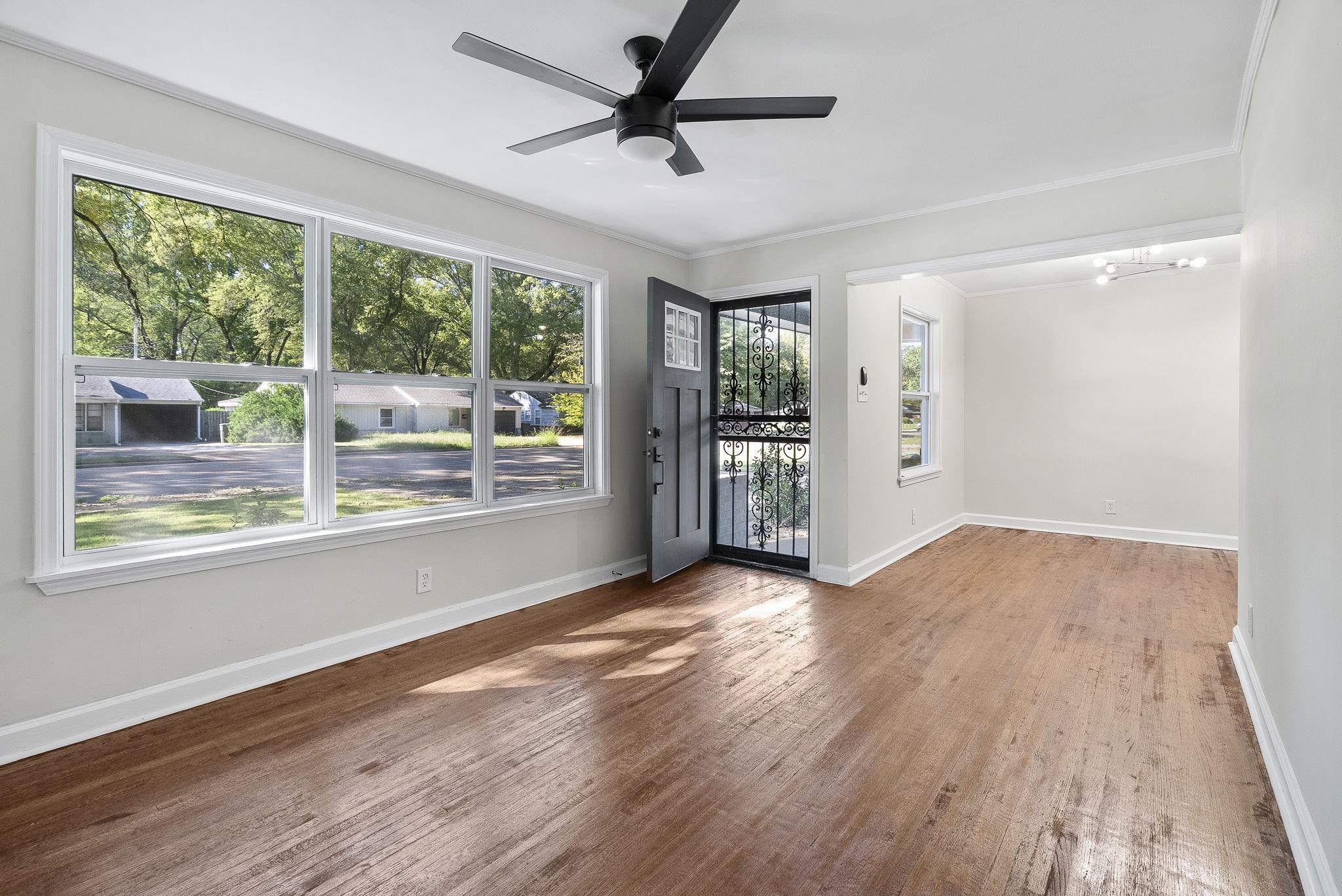 1168 South Perkins Road Memphis, TN 38117 - Photo 8 of 34 a view of empty room with wooden floor and fan