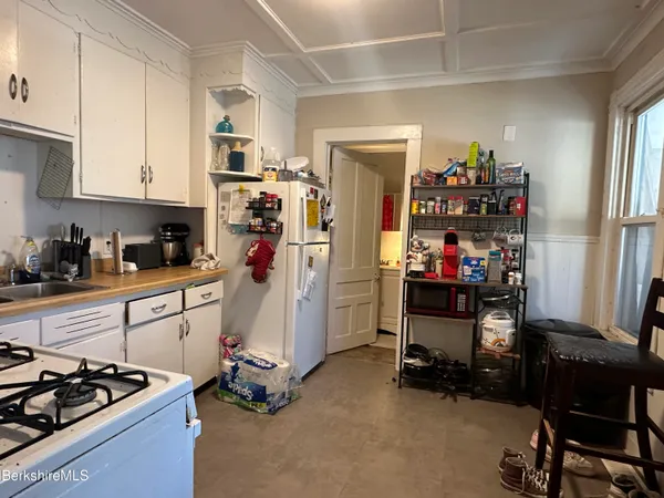 a bedroom with furniture and a flat screen tv