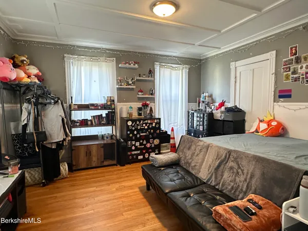 a bedroom with a bed window and a television