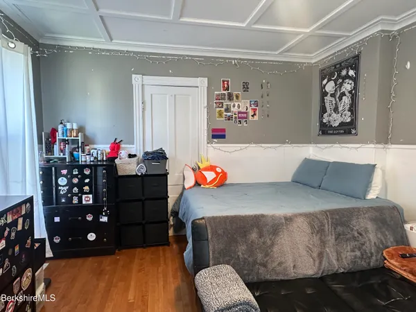 a bedroom with furniture and a window