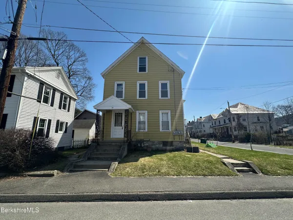 a front view of a house with a yard