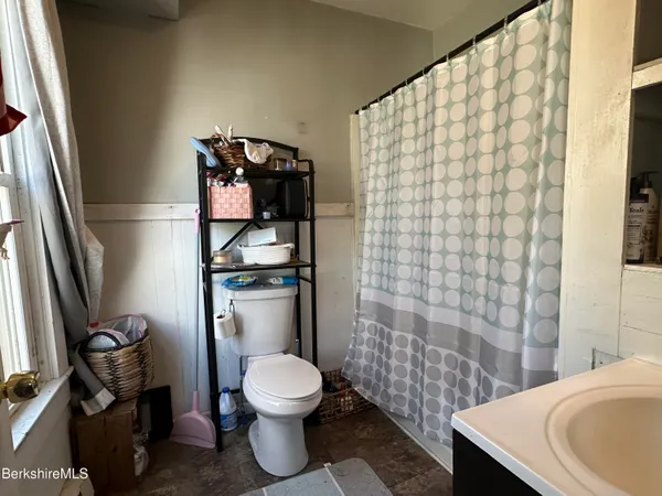 a bathroom with a toilet and a mirror