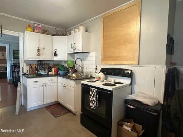 a view of a dining room with furniture a rug and wooden floor