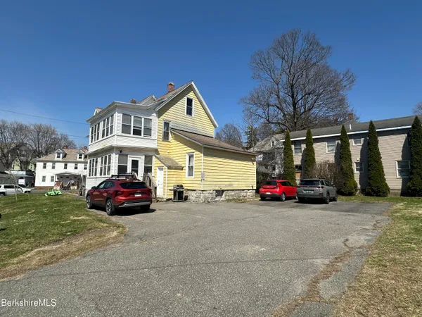 a view of a car parked in front of a house