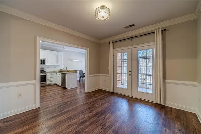 a view of a room with wooden floor