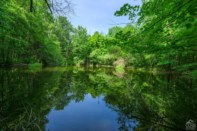 an aerial view of a house with a yard and lake view