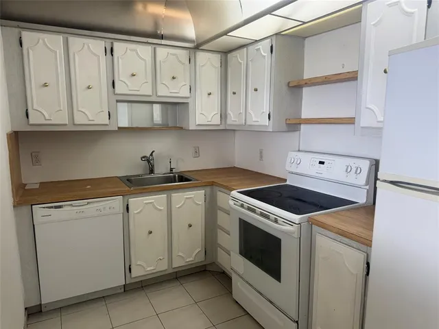 a utility room with cabinets washer and dryer