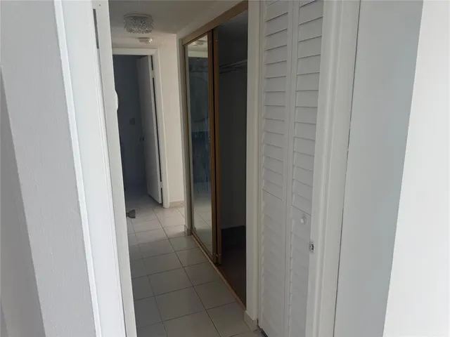 a view of an empty room with a closet