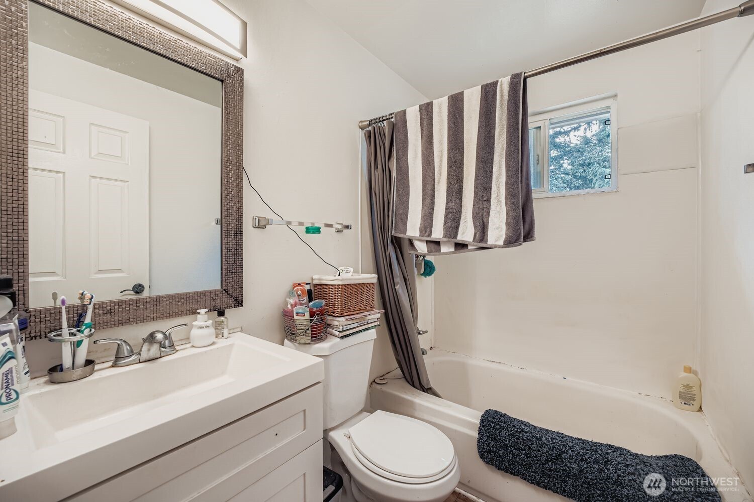 1126 Neil Street Northeast Olympia, WA 98516 - Photo 12 of 21 a bathroom with a sink a toilet and a bathtub