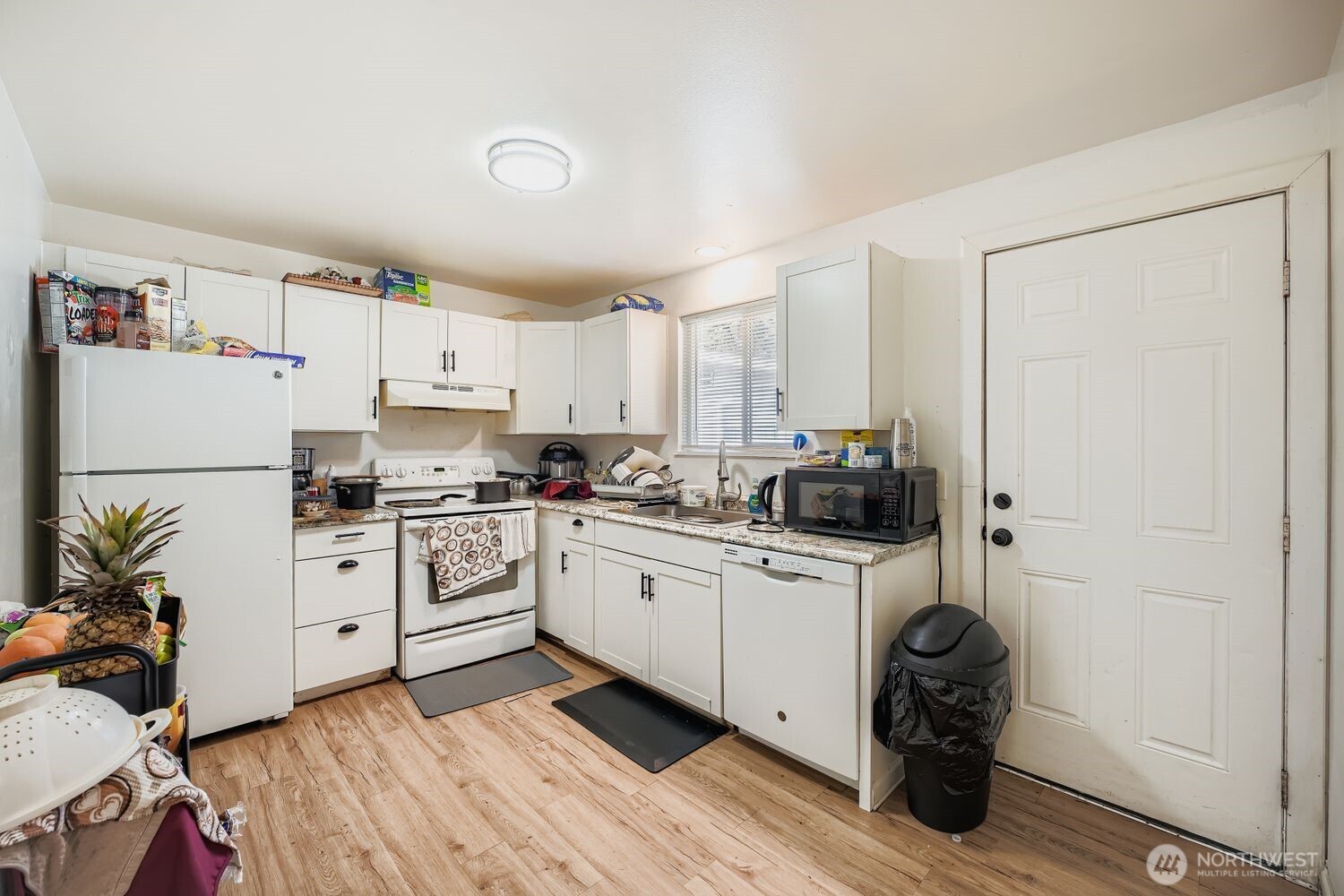 1126 Neil Street Northeast Olympia, WA 98516 - Photo 13 of 21 a kitchen with white cabinets and white appliances