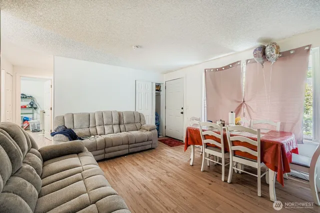 a living room with furniture wooden floor and a window