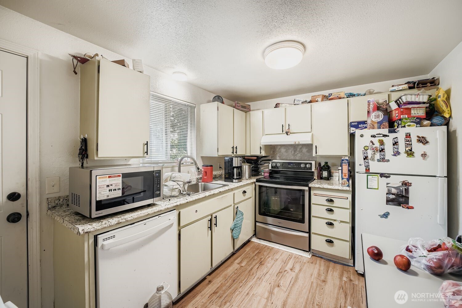 1126 Neil Street Northeast Olympia, WA 98516 - Photo 9 of 21 a kitchen with stainless steel appliances a stove a sink and a refrigerator