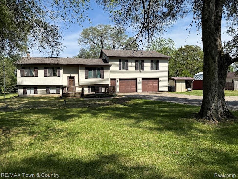 4372 North Gale Road Davison, MI 48423 - Photo 1 of 46 Split-level residence featuring light-colored siding, dark shutters, and a front deck