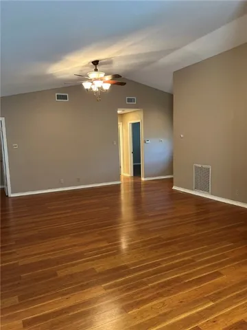 a view of a room with wooden floor