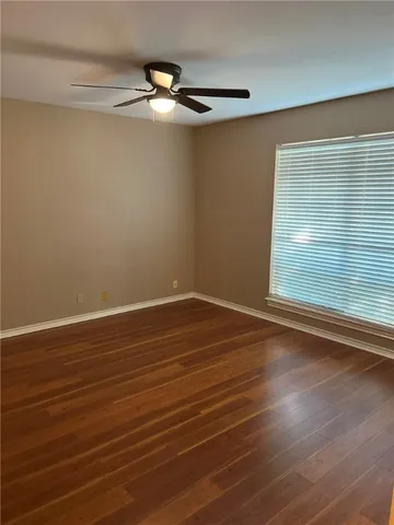 a view of a room with wooden floor