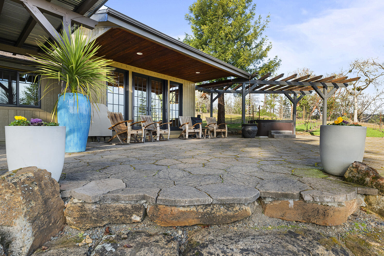 1052 Holcomb Springs Road Gold Hill, OR 97525 - Photo 3 of 65 Covered Stone Patio with Seating Area