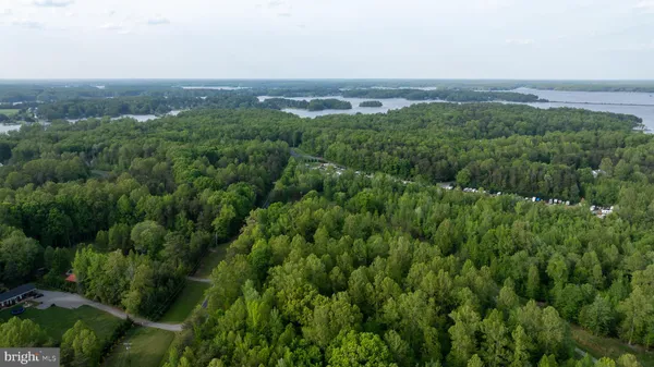 an aerial view of residential houses with outdoor and green space