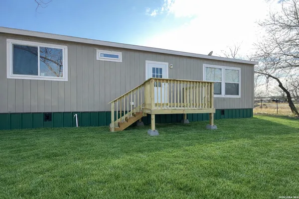 a view of a house with a backyard
