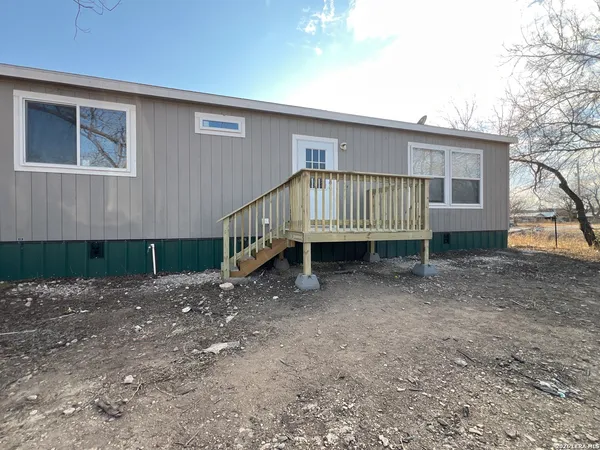 a view of a house with a yard and deck