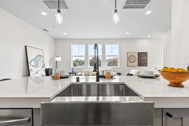 a kitchen that has a sink cabinets and a stove