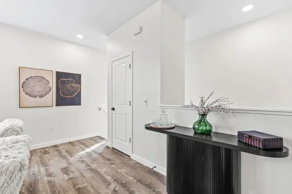 a view of an entryway with wooden floor