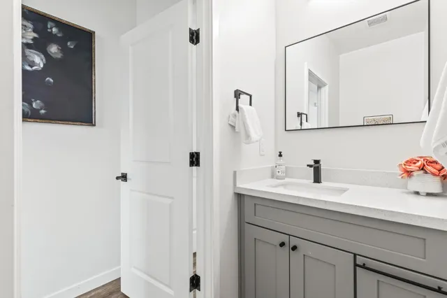 a bathroom with a sink vanity and mirror
