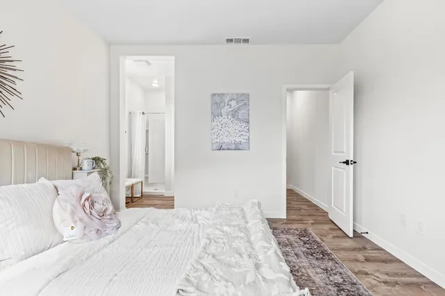 a bedroom with a large bed and a window